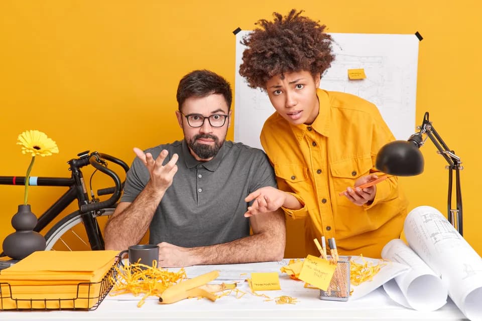 Colleagues reviewing plans together in a creative workspace
